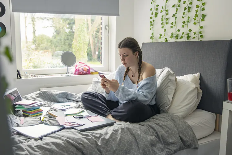 Parent reading with child on bed